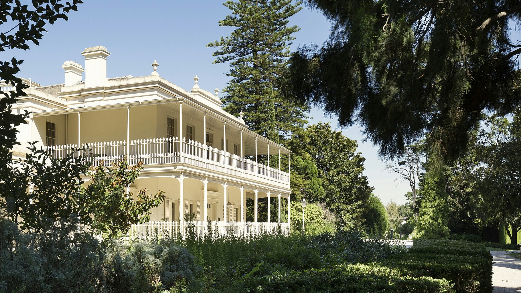 Side view of Como House exterior and garden path.